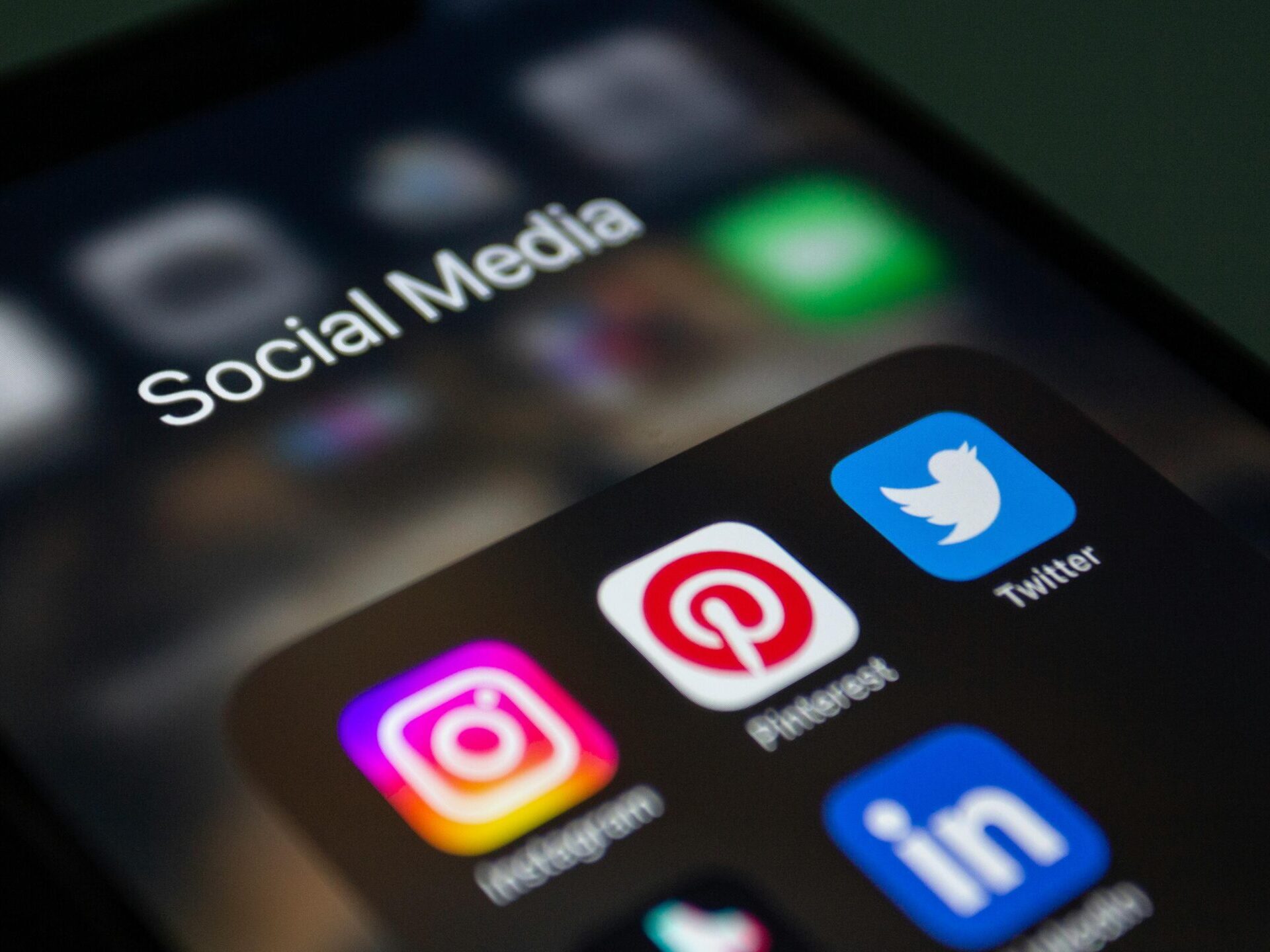 A smartphone screen displaying popular social media applications like Instagram and Twitter.