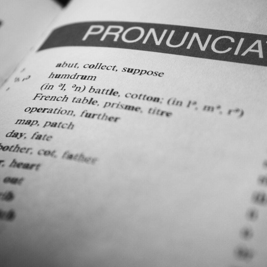Black and white close-up of a dictionary page focused on pronunciation guides and phonetic symbols.