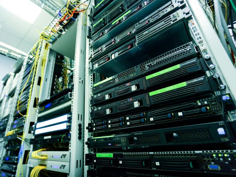 High-tech server rack in a secure data center with network cables and hardware components.